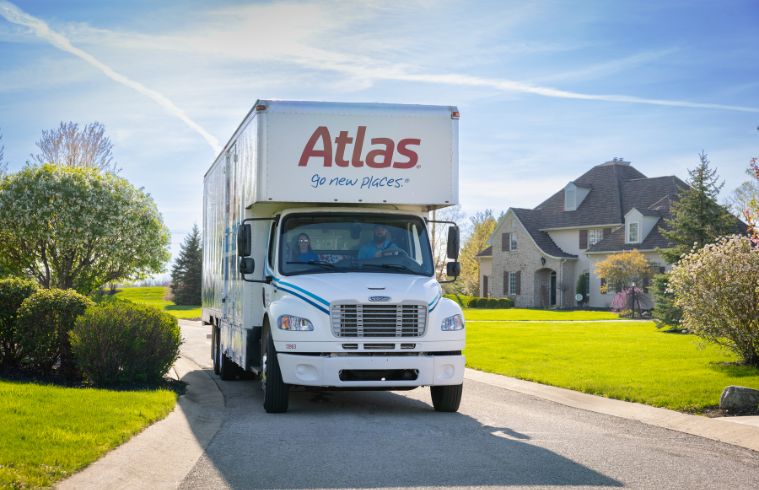 Atlas truck parked in front of a house, ready for loading or unloading belongings.