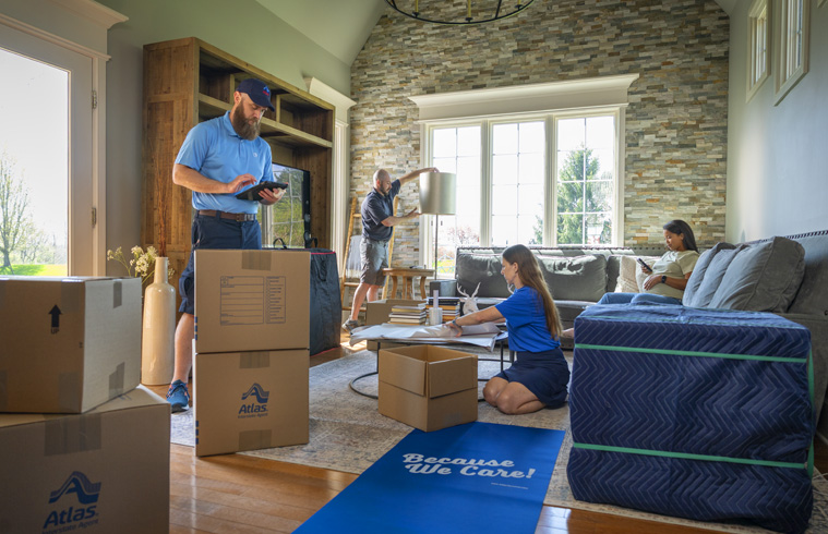 Atlas moving agents arranging boxes for home relocation.