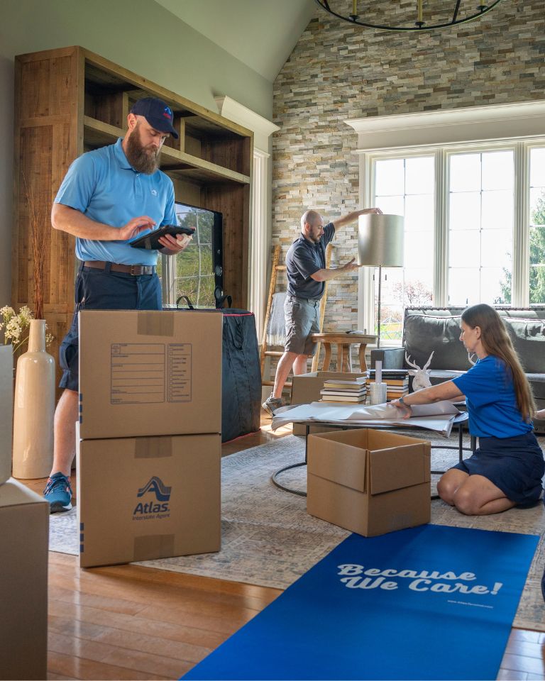 atlas employees packing boxes for a move