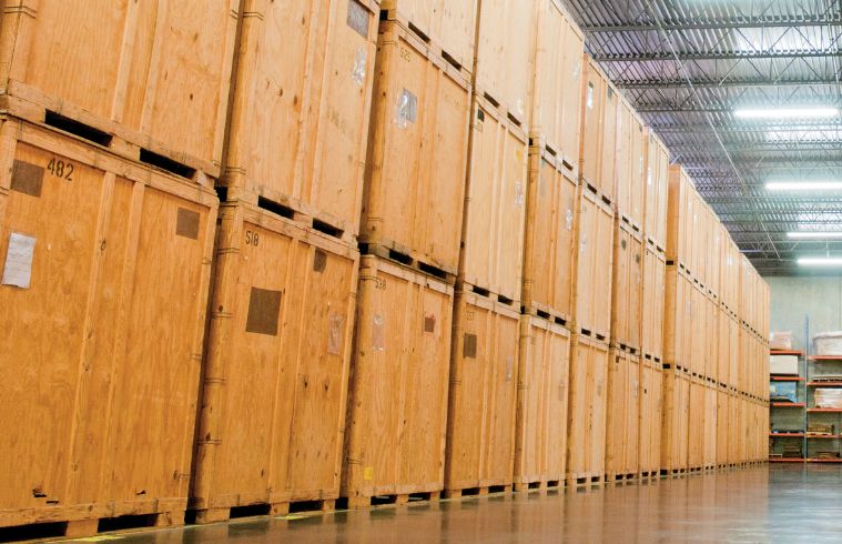 A spacious warehouse filled with stacked wooden crates, showcasing an organized storage area.